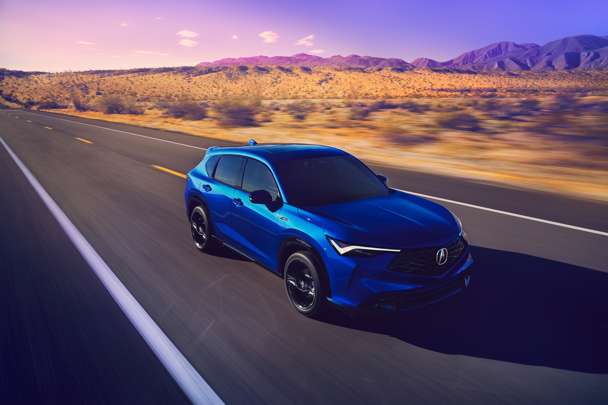 2025 Acura ADX A-Spec in blue driving on a desert highway