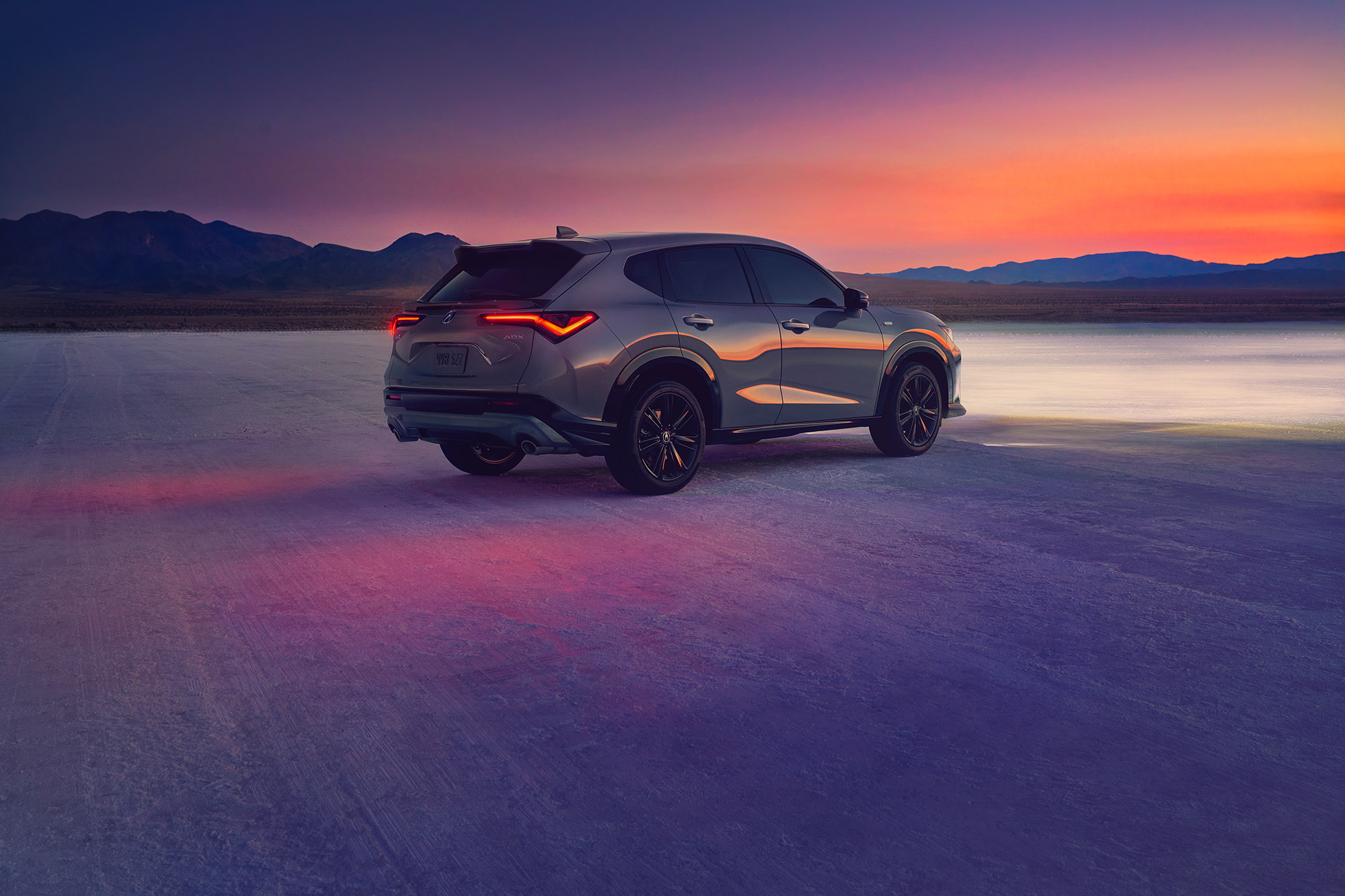 2025 Acura ADX A-Spec in gray parked on desert dry lakebed, rear