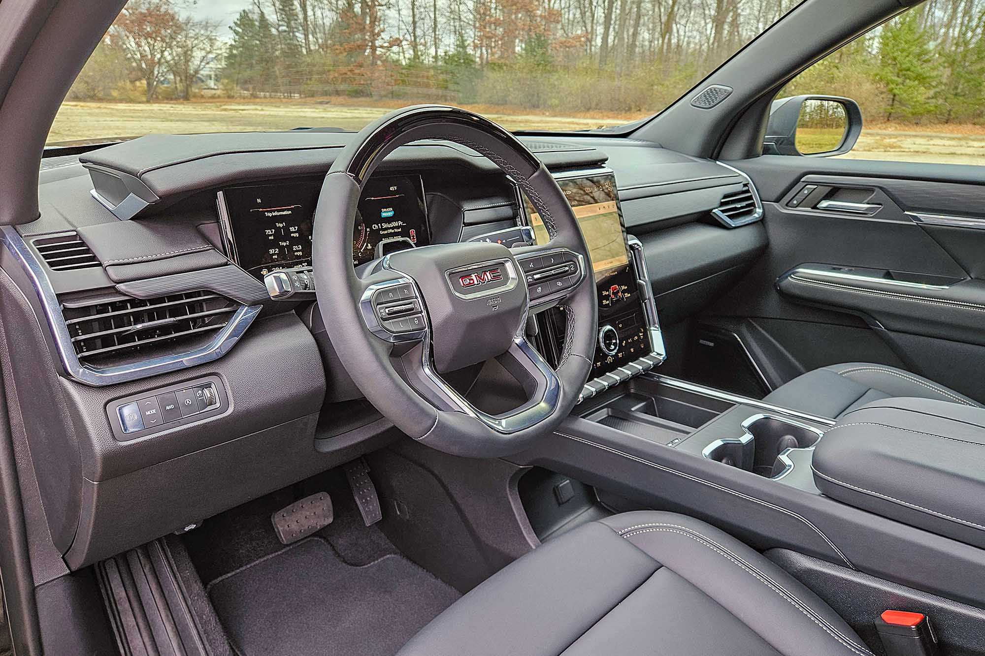 2024 GMC Acadia interior showing the dashboard, center console, and front seats.