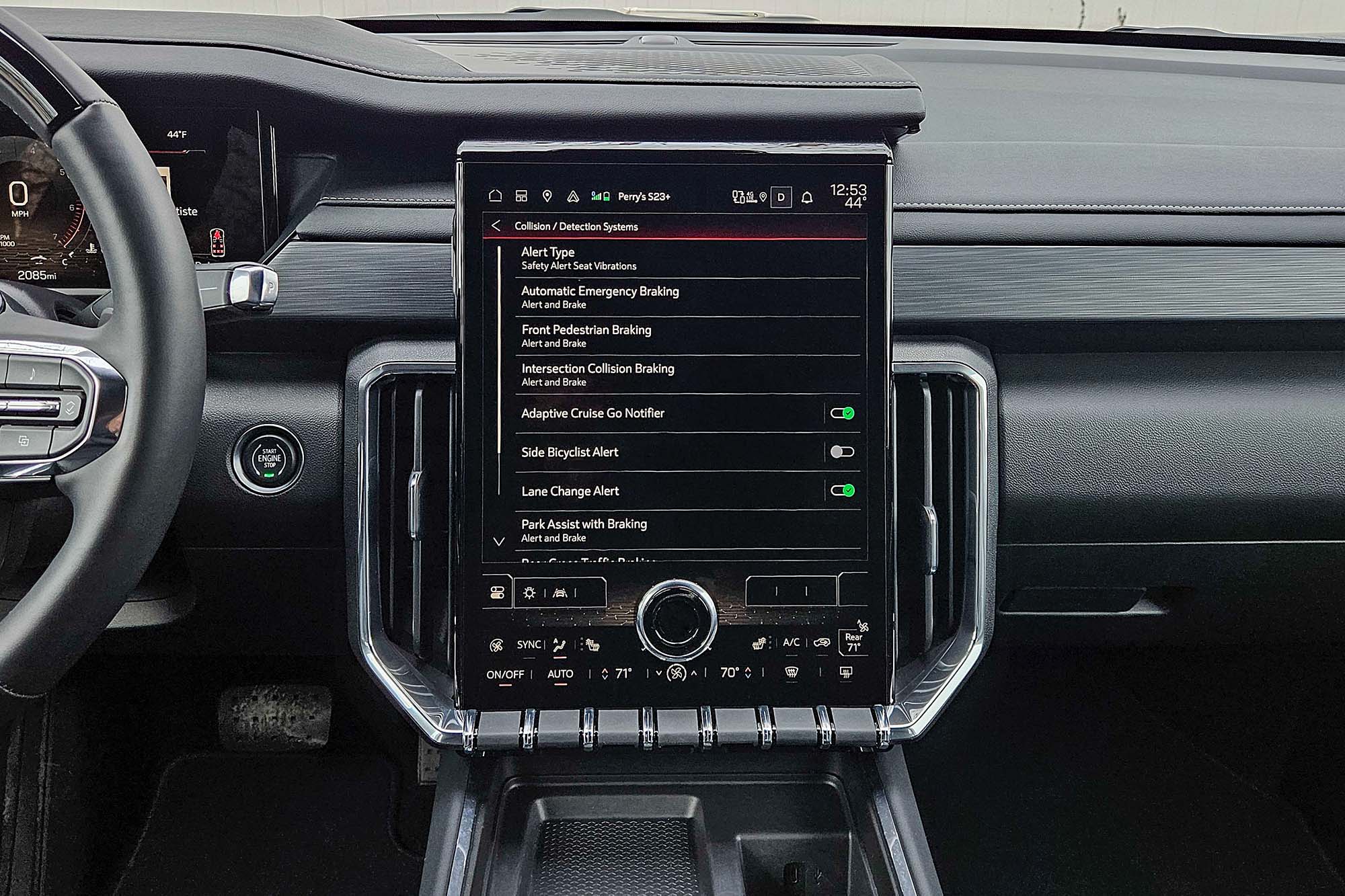 2024 GMC Acadia interior showing the safety features menu on the infotainment screen.