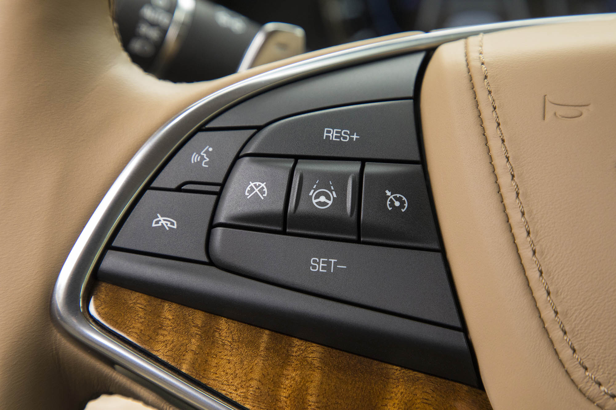 An array of buttons placed on the left spoke of a steering wheel