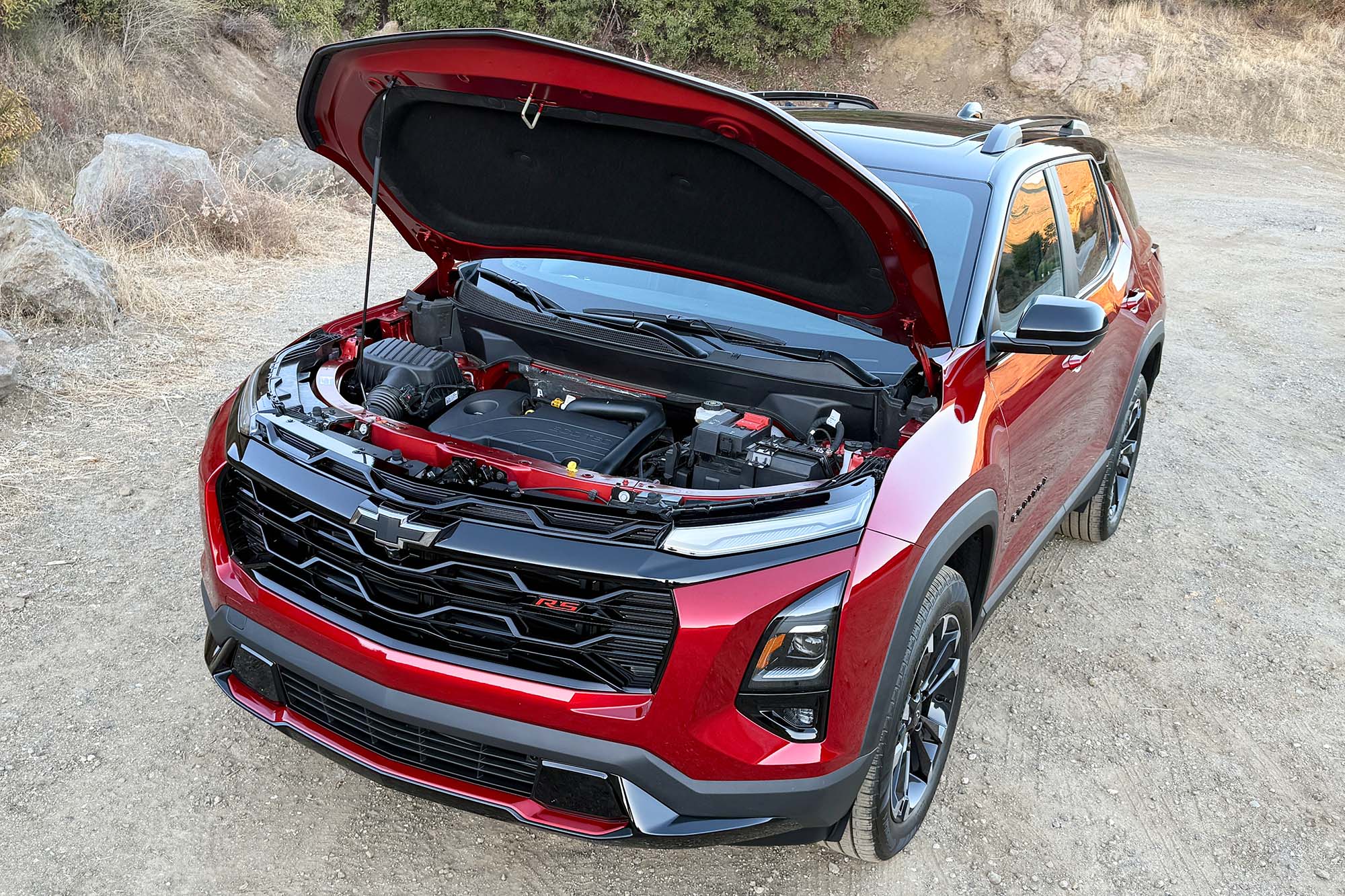 2025 Chevrolet Equinox RS in Radiant Red, shown with the hood open to see the engine.