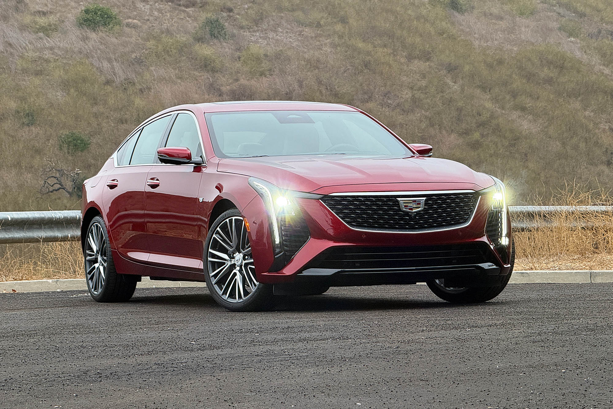 2025 Cadillac CT5 Premium Luxury in Radiant Red parked in front of a hillside