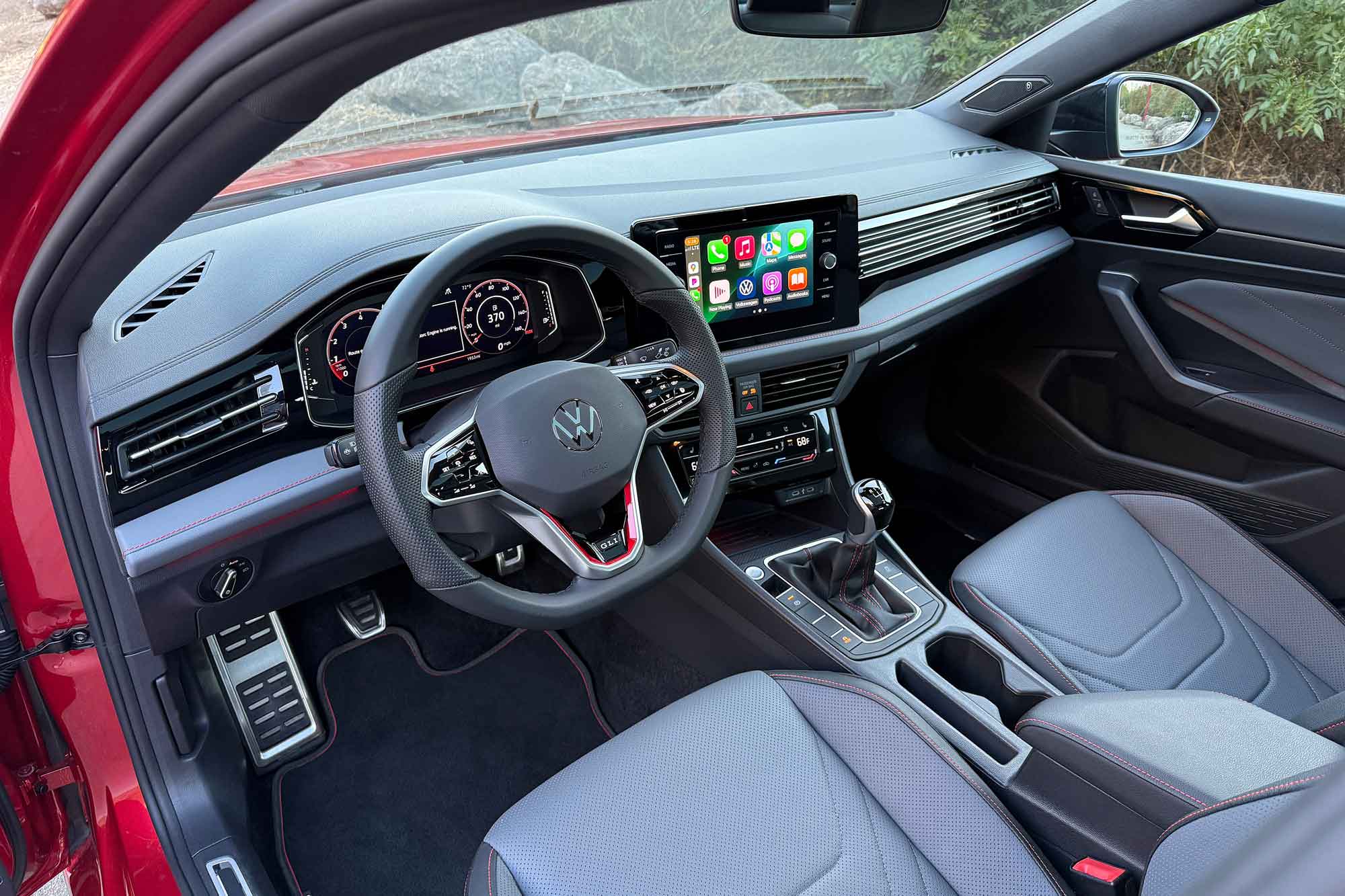 2025 Volkswagen Jetta GLI interior showing the dashboard, manual transmission, and front seats.