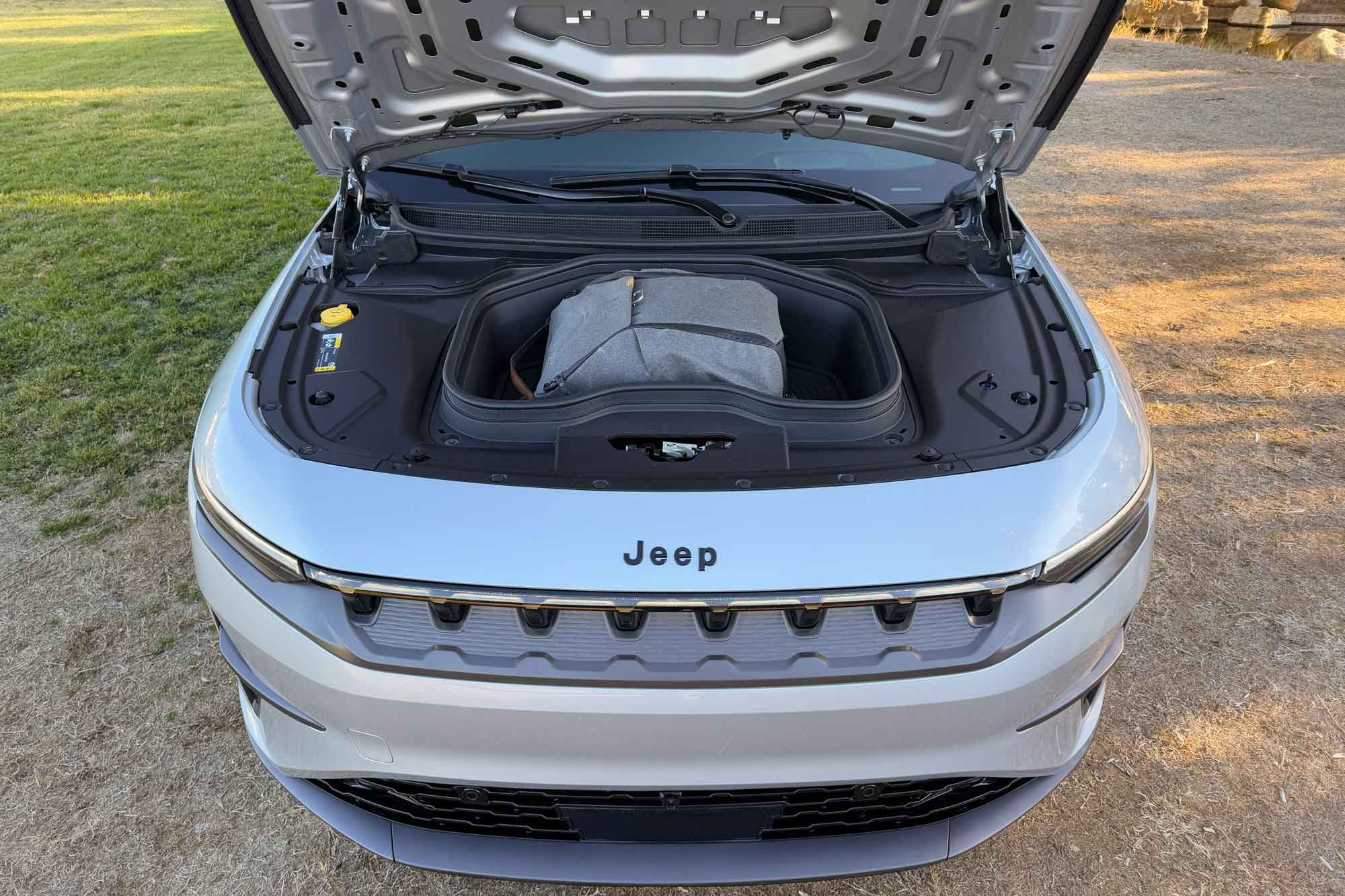 2024 Jeep Wagoneer S Launch Edition in Silver Zynith showing a backpack placed in the front trunk (frunk).