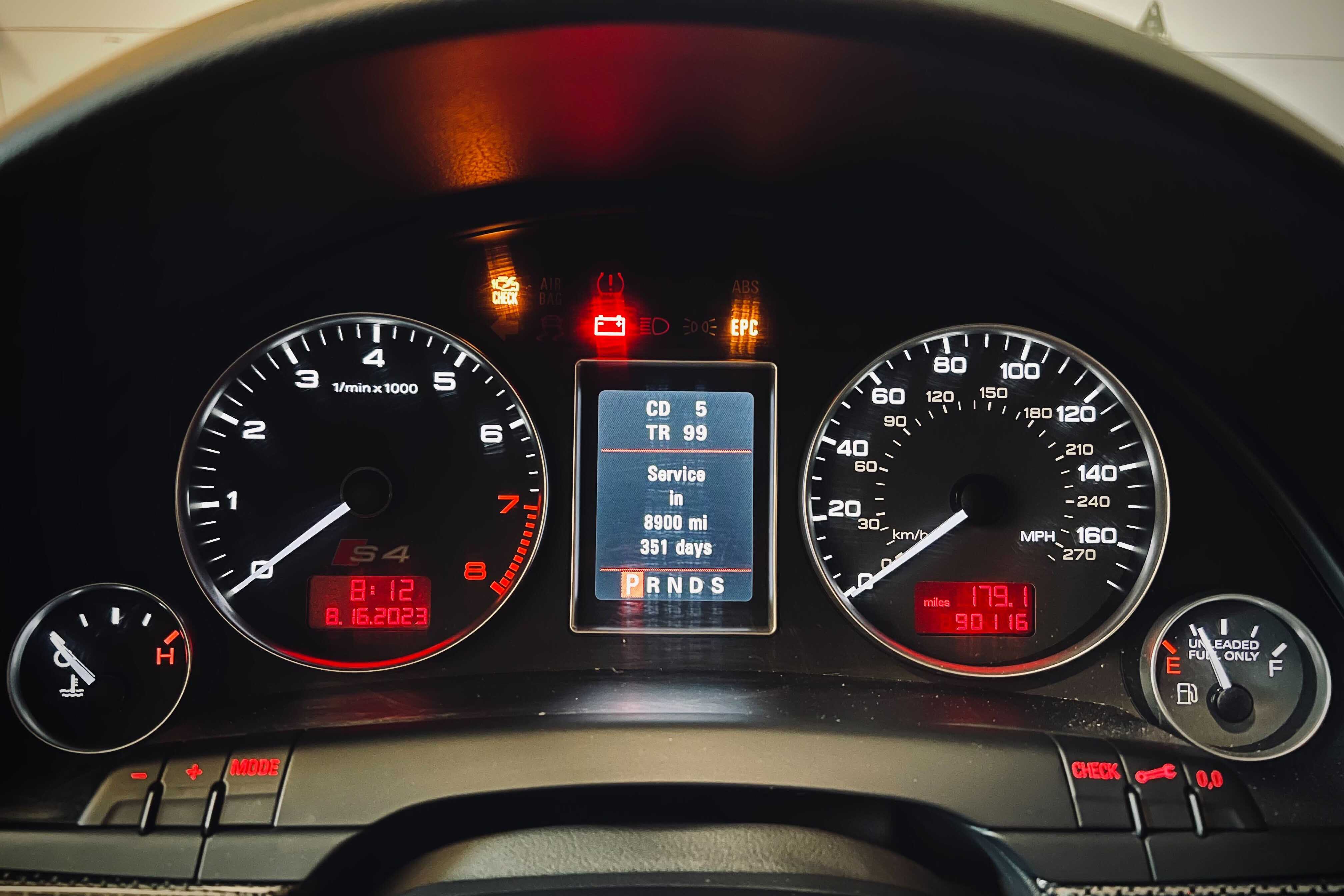 Dashboard of car with warning lights illuminated