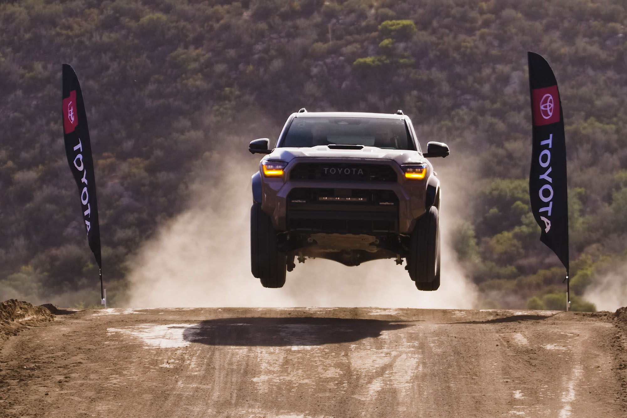 A 2025 Toyota 4Runner jumping on an off-road course.