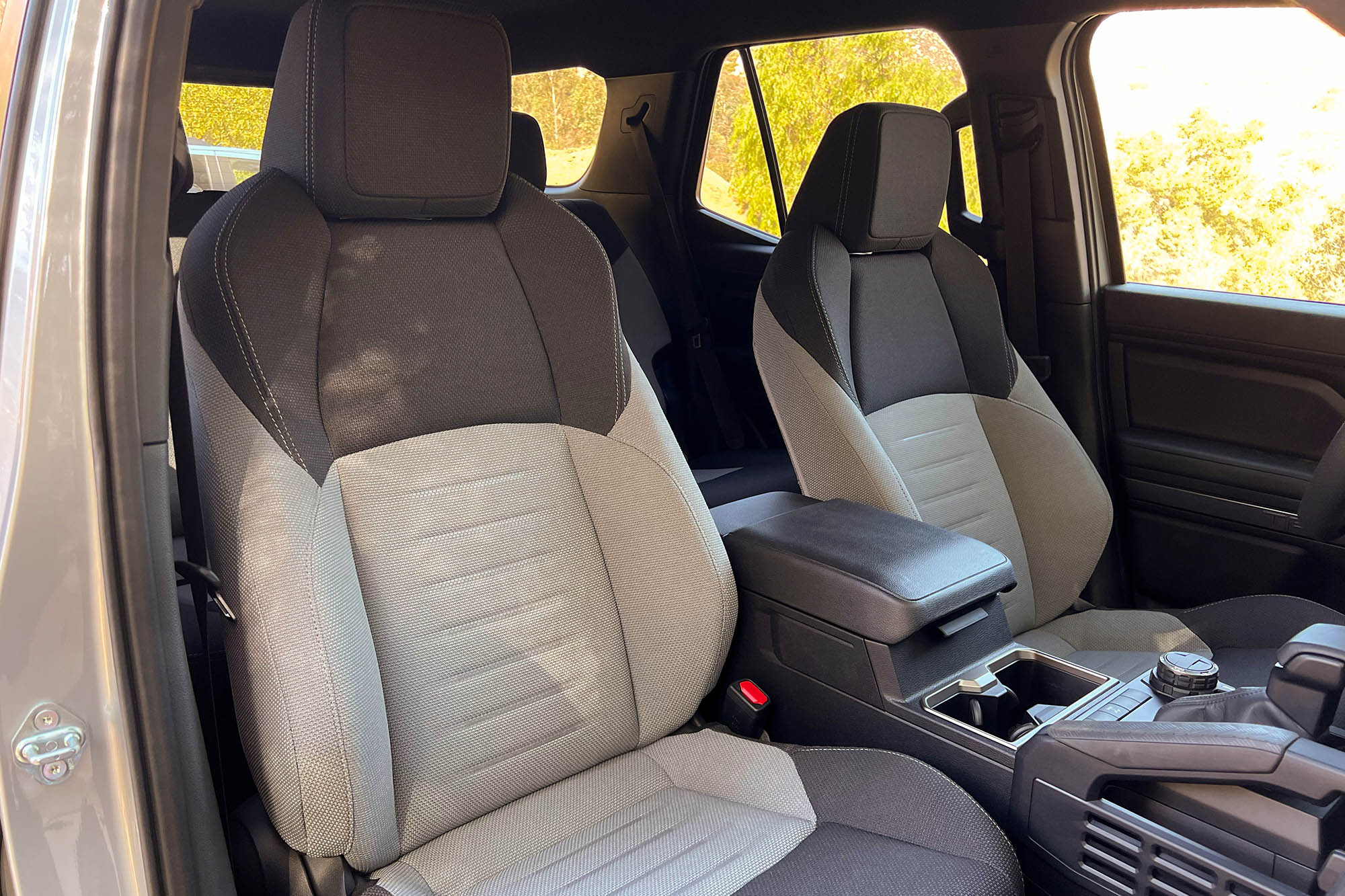 2025 Toyota 4Runner TRD Off-Road interior showing the two-tone black and gray cloth front seats.