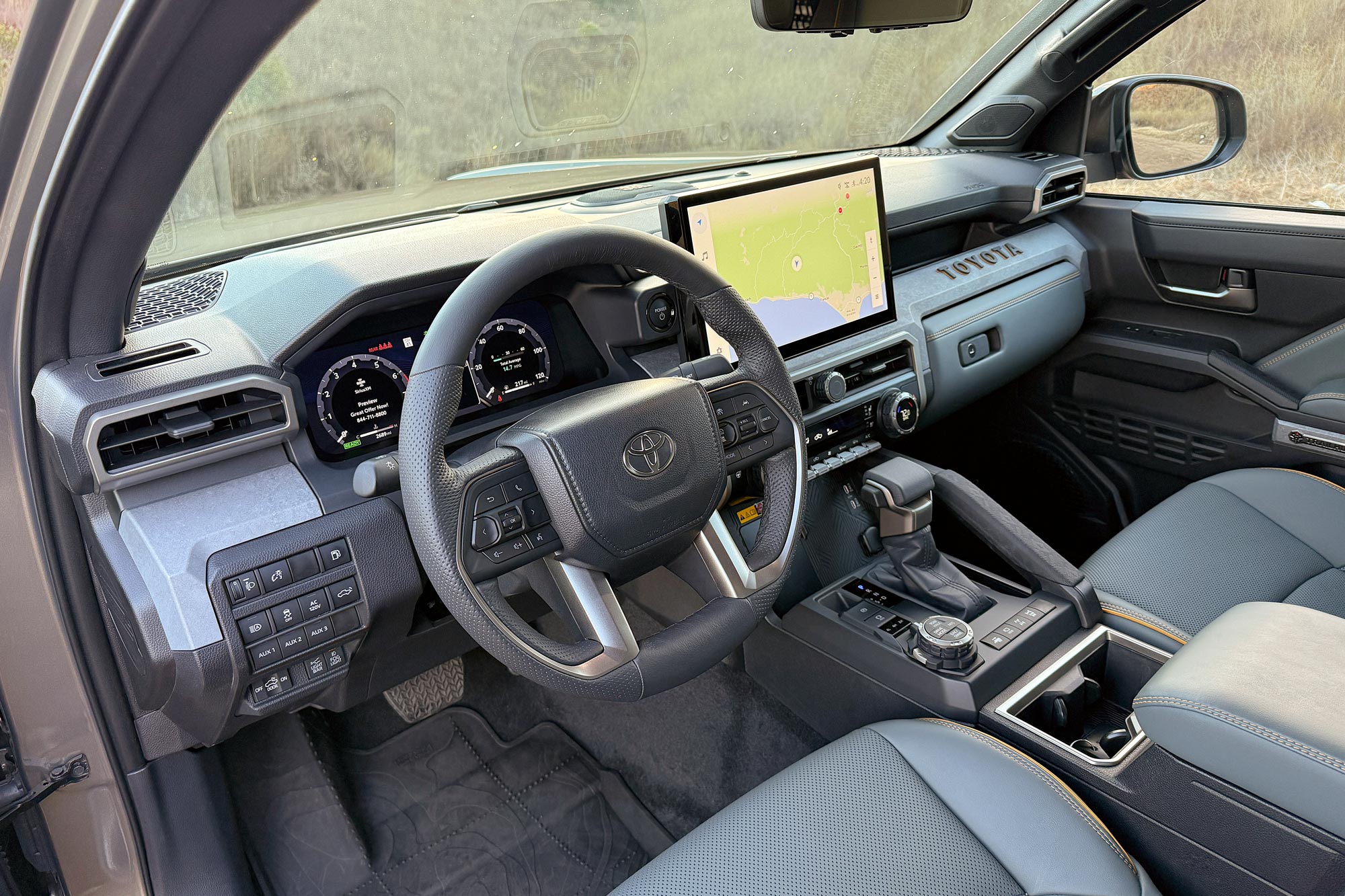 2024 Toyota Tacoma Trailhunter interior showing the dashboard and center console with off-road system controls