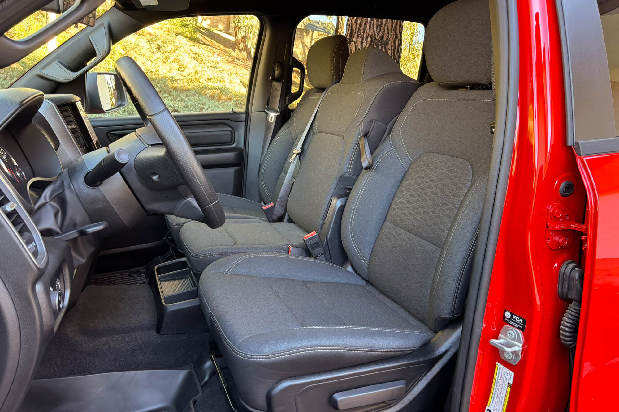 2025 Ram 1500 Warlock interior showing the bench front seat with cloth upholstery.