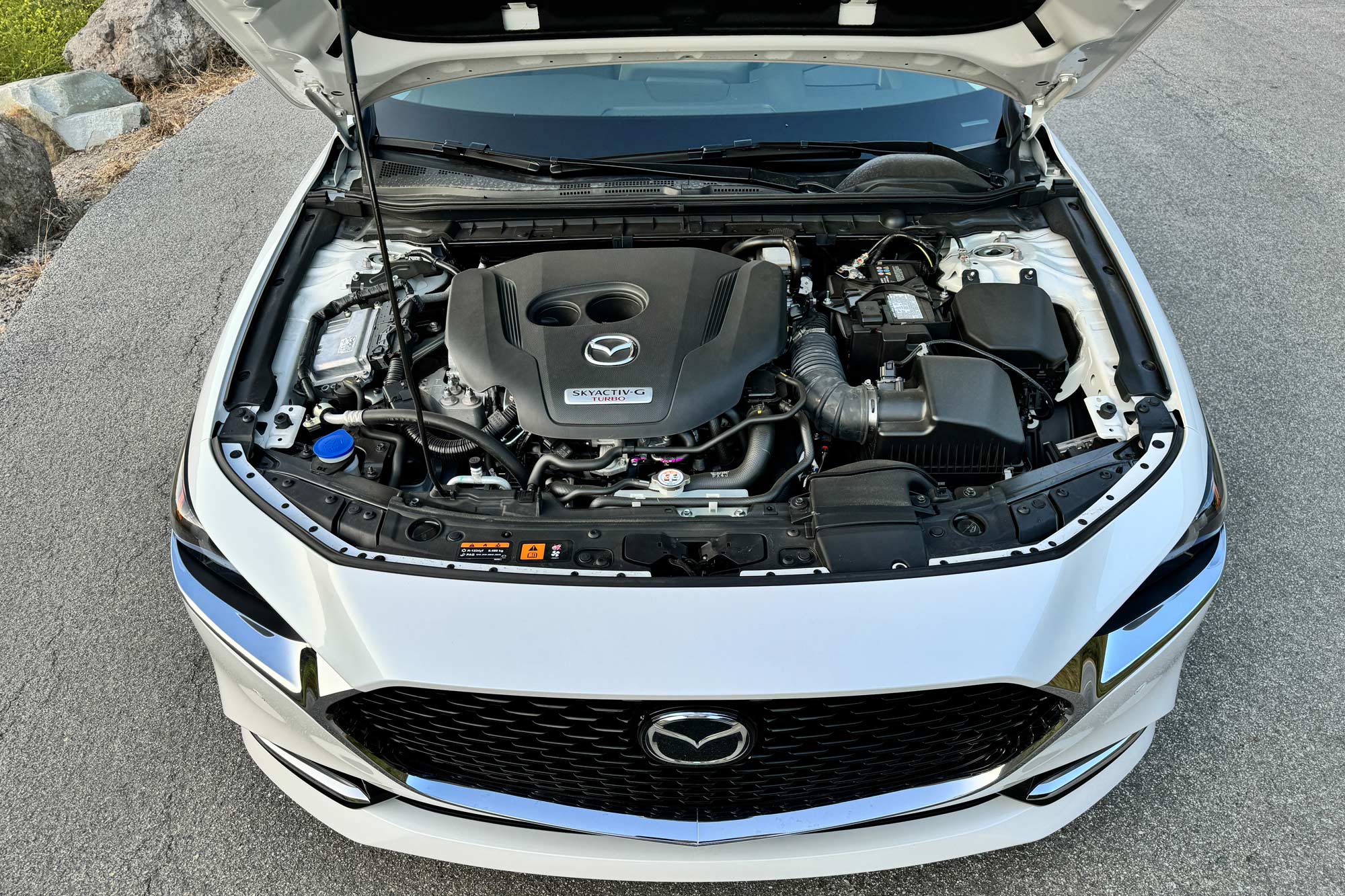 View of a 2024 Mazda 3 2.5 Turbo Sedan's turbocharged engine.