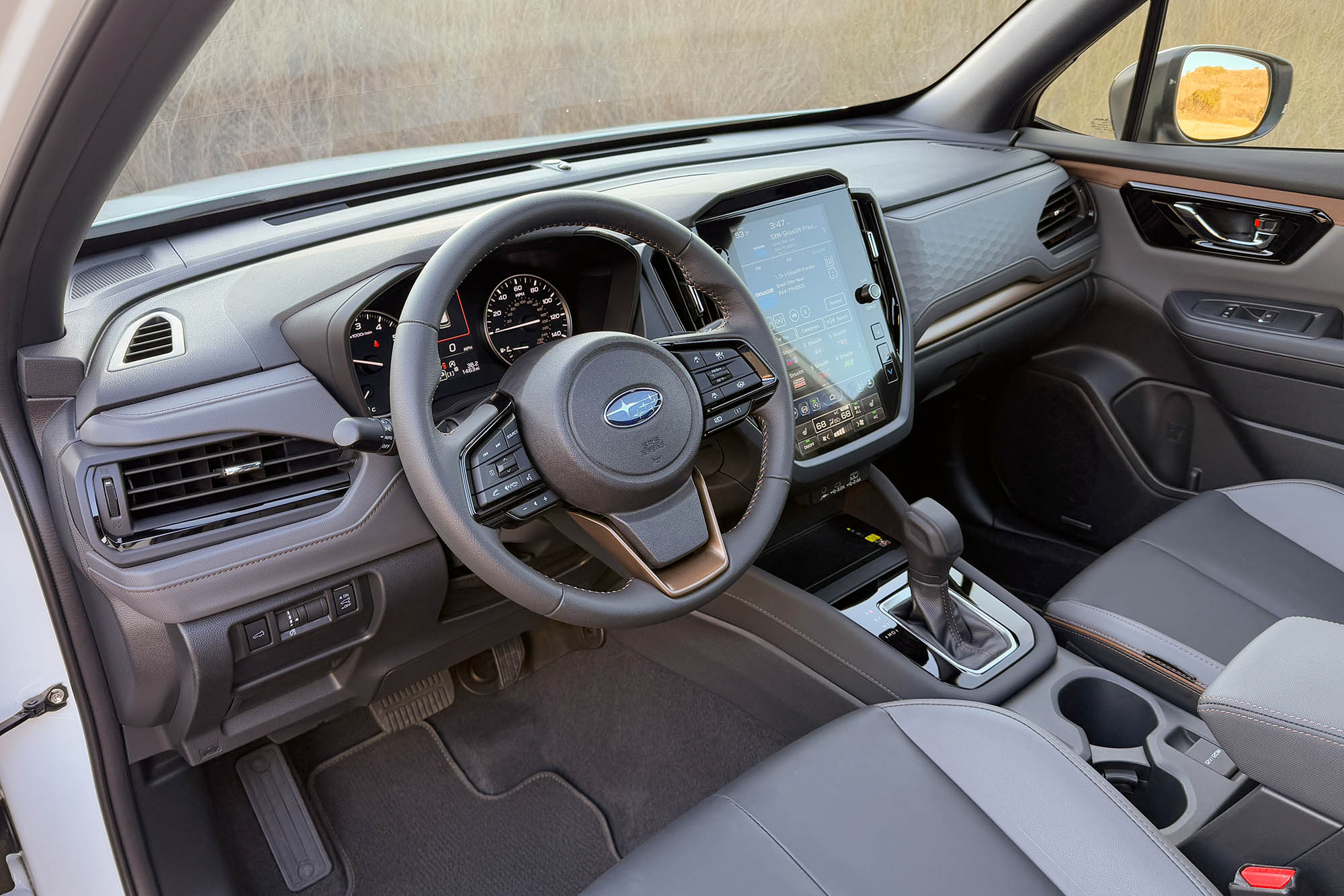 2025 Subaru Forester Sport interior showing the dashboard, center console, and front seats.