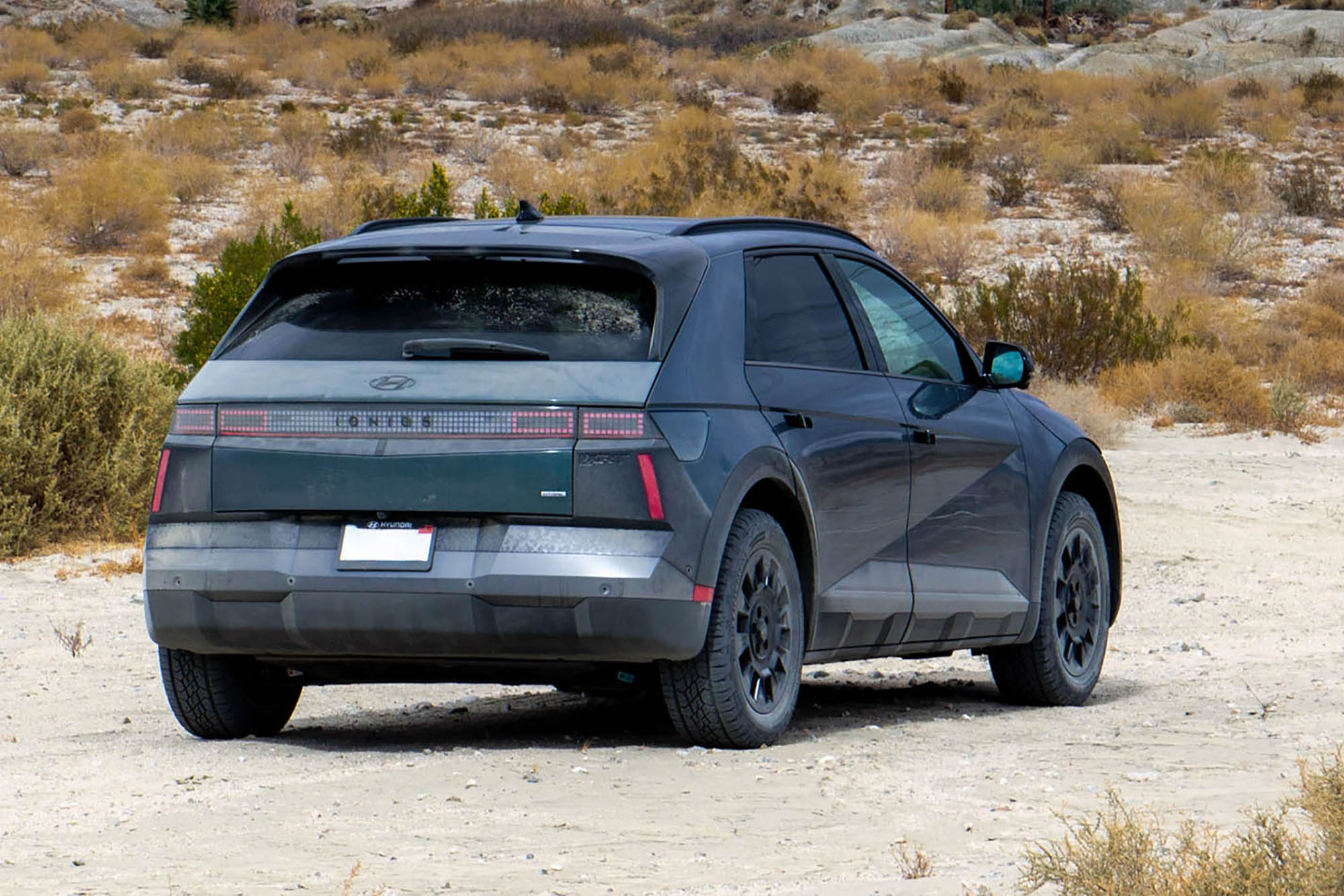 2025 Hyundai Ioniq 5 XRT in Digital Teal, rear, with desert in the background.