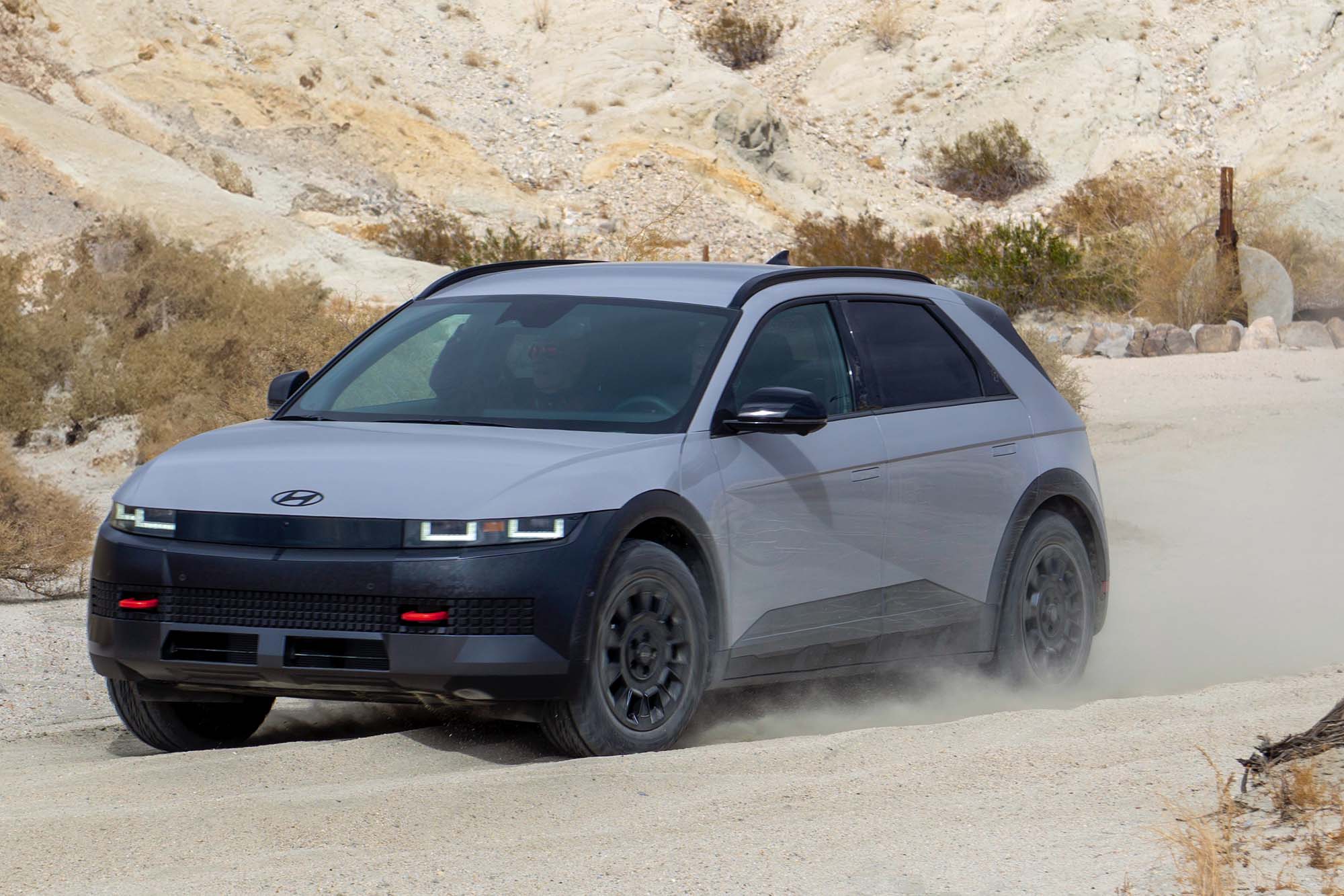 2025 Hyundai Ioniq 5 XRT in Cyber Gray churning through sand in the desert.