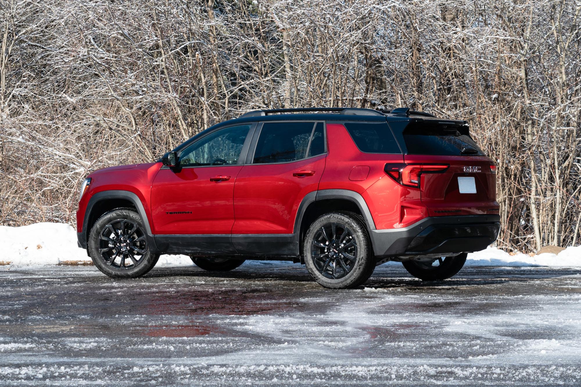 2025 GMC Terrain Elevation in Volcanic Red with snow and trees in the background.