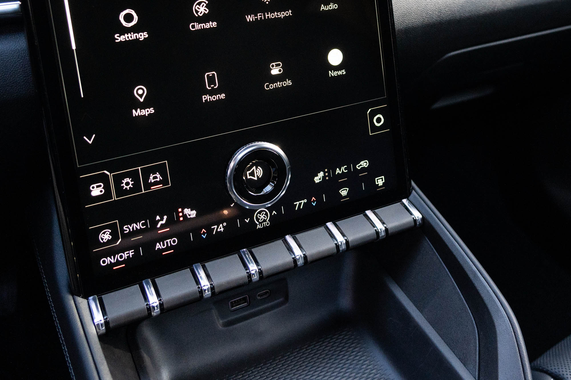 2025 GMC Terrain Elevation interior showing the climate control toggle switches and stereo volume knob.