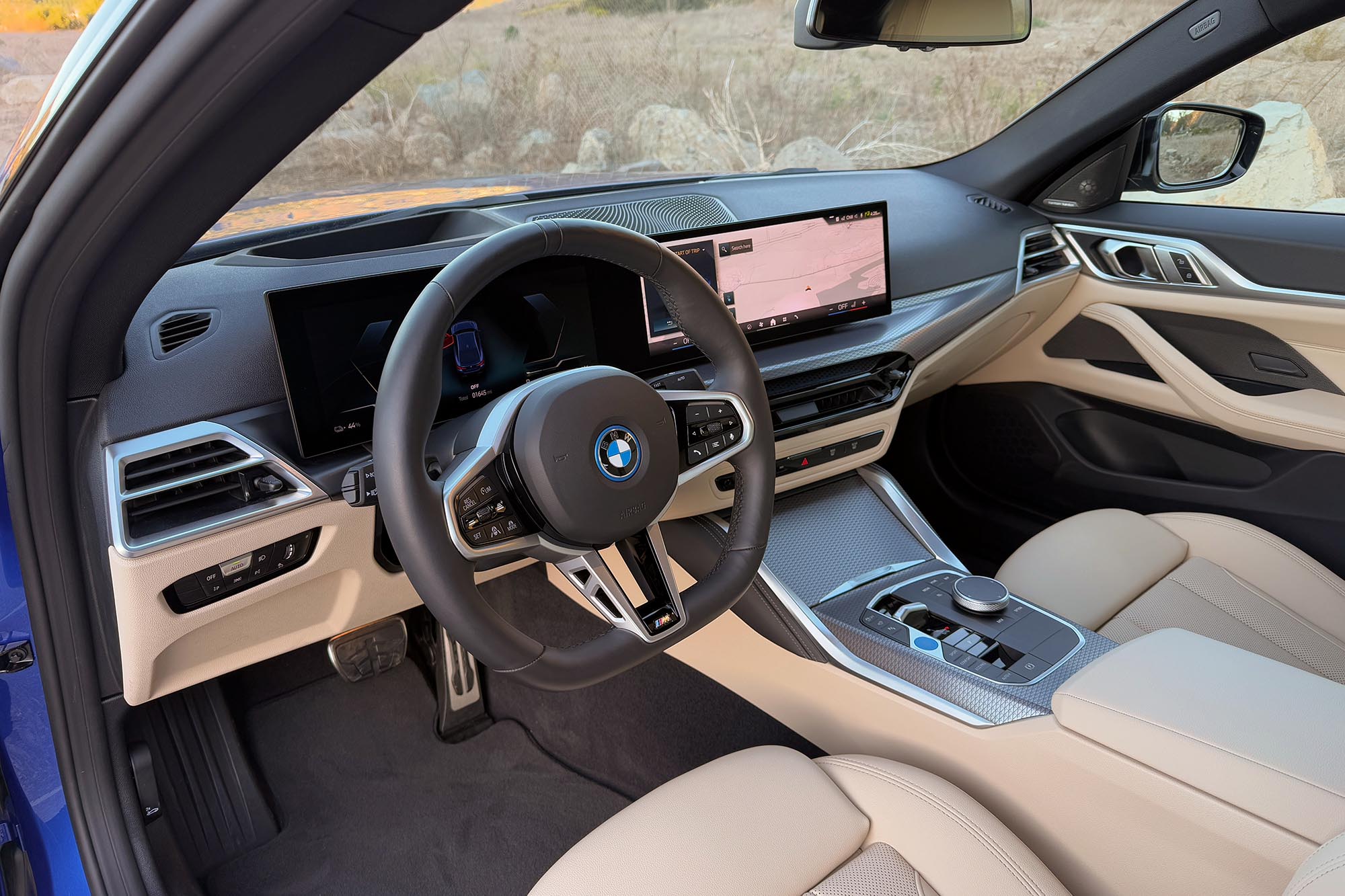 2025 BMW i4 eDrive40 interior showing the dashboard, center console, and front seats.