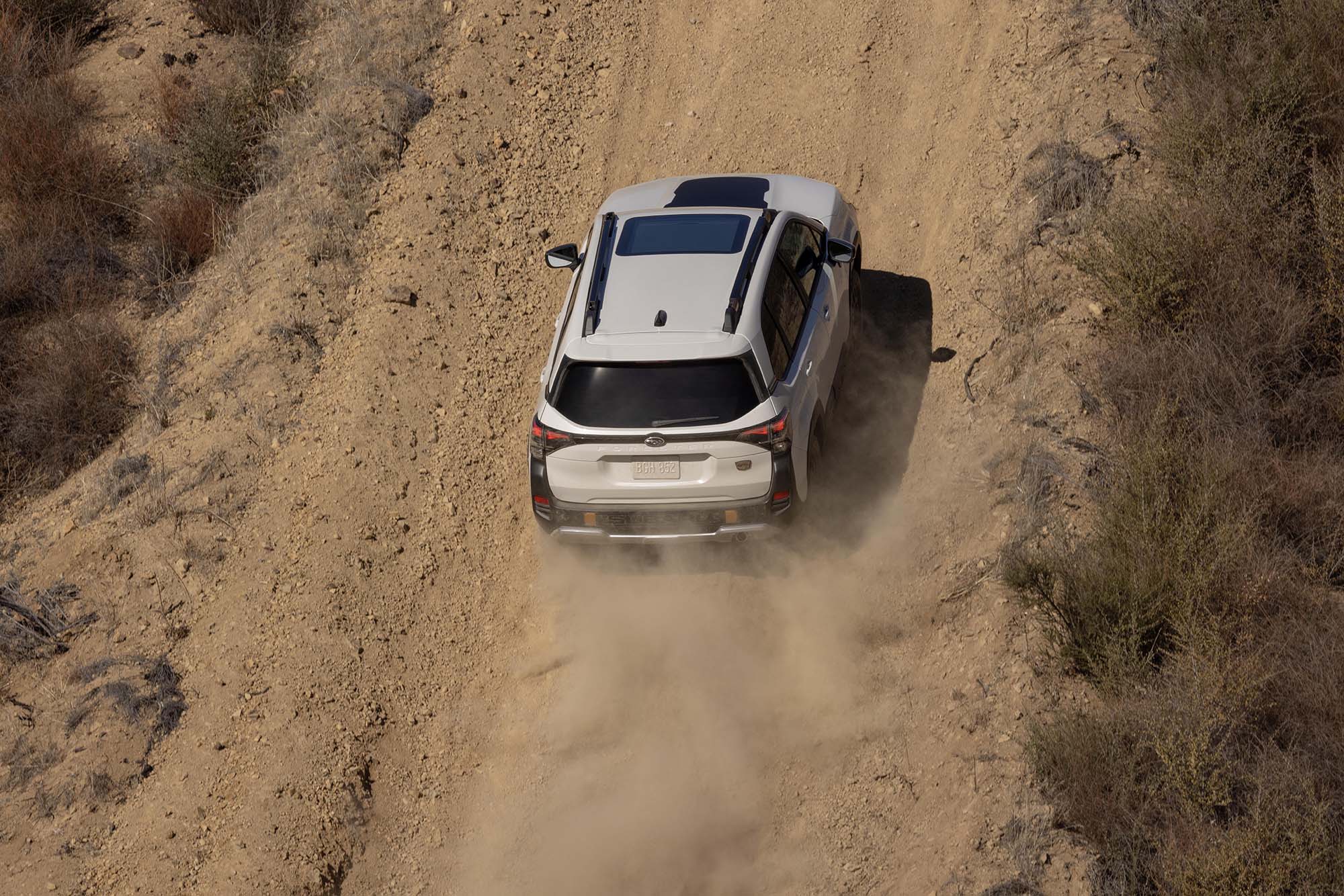 White 2026 Subaru Forester Wilderness climbing a mountain road.