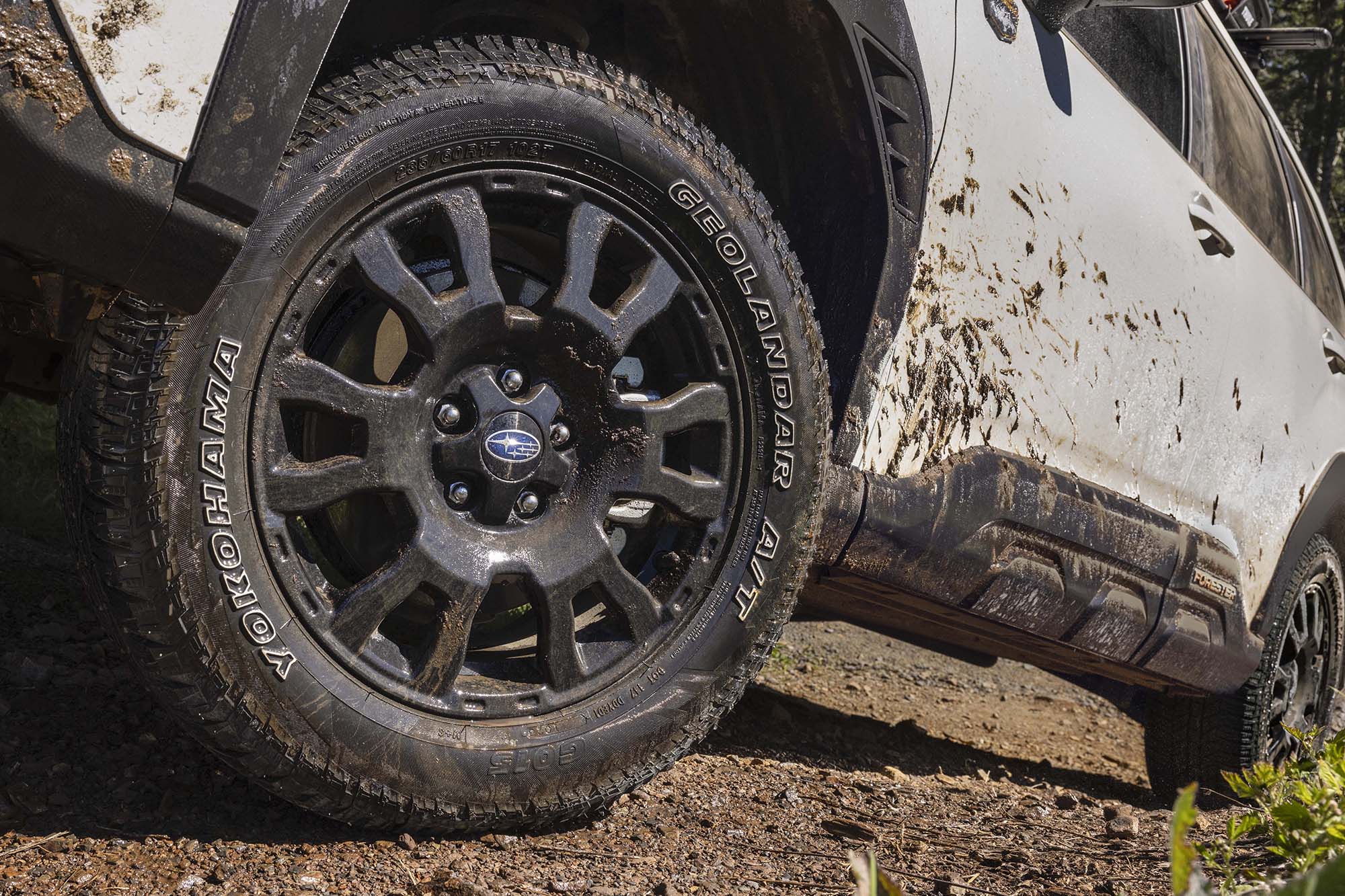 White 2026 Subaru Forester Wilderness tires spattered in mud.